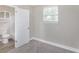 Bedroom showing an ensuite bathroom with tile surround and window at 21042 Gladis Ave, Port Charlotte, FL 33952