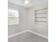 This bedroom has carpeted floors and a built-in shelving unit at 21042 Gladis Ave, Port Charlotte, FL 33952