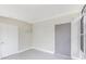 An enclosed bonus room with painted walls, access door, and windows for natural light at 21042 Gladis Ave, Port Charlotte, FL 33952