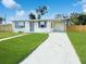 Charming single story home featuring a carport, well maintained lawn, and a freshly painted exterior at 21042 Gladis Ave, Port Charlotte, FL 33952