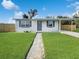 Charming single story home with a well maintained lawn, freshly painted exterior, and carport at 21042 Gladis Ave, Port Charlotte, FL 33952