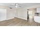 Open-concept living room flows into kitchen, featuring plank floors, ceiling fan, and neutral paint at 21042 Gladis Ave, Port Charlotte, FL 33952