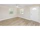 Sunlit living room featuring updated plank floors, ceiling fan, and neutral paint at 21042 Gladis Ave, Port Charlotte, FL 33952