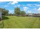 Spacious back yard that is lush and green leading to a waterfront view and mature trees at 2156 Egret Dr, Clearwater, FL 33764