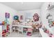 Bright bedroom with loft bed, shelves, and vanity area at 2265 Alee Ln, Wesley Chapel, FL 33543