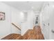 Upstairs hallway with wood floors and white walls, leading to multiple bedrooms at 2265 Alee Ln, Wesley Chapel, FL 33543