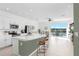 Open kitchen with modern appliances, large island, and seamless flow into the living area and waterfront patio at 2265 Alee Ln, Wesley Chapel, FL 33543