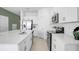 Modern kitchen with white cabinets, stainless steel appliances, an island with seating, and open layout at 2265 Alee Ln, Wesley Chapel, FL 33543
