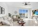 Bright living room featuring cozy furniture, large windows, and stylish décor, creating an inviting space at 2265 Alee Ln, Wesley Chapel, FL 33543