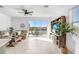Bright living room with tile floors, ceiling fan, and sliding glass doors overlooking the lake at 2265 Alee Ln, Wesley Chapel, FL 33543