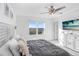 Bright main bedroom features a ceiling fan, coastal decor, and a large window with a view at 2265 Alee Ln, Wesley Chapel, FL 33543