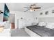 Bright main bedroom featuring a ceiling fan, dresser and coastal decor at 2265 Alee Ln, Wesley Chapel, FL 33543