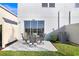 Outdoor patio with furniture, sliding glass door and small patch of grass at 2265 Alee Ln, Wesley Chapel, FL 33543