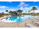 Inviting community pool surrounded by lush landscaping and comfortable lounge chairs at 2265 Alee Ln, Wesley Chapel, FL 33543