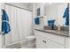 Clean bathroom featuring a vanity with granite countertop, white cabinets, sink and a shower with curtain at 2835 Hilliard Dr, Wesley Chapel, FL 33543