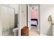 Bathroom with a toilet, shower with floral curtain and an open doorway to the bedroom at 2835 Hilliard Dr, Wesley Chapel, FL 33543