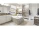 Bright and modern bathroom with a soaking tub, walk-in shower, and double vanity at 2835 Hilliard Dr, Wesley Chapel, FL 33543