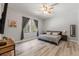 Cozy bedroom with wood flooring, ceiling fan, and natural light at 2835 Hilliard Dr, Wesley Chapel, FL 33543