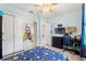 Bright bedroom features a ceiling fan, light blue walls, wood floors, closet, and a gaming setup at 2835 Hilliard Dr, Wesley Chapel, FL 33543