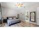 Cozy bedroom with neutral tones and a ceiling fan, connected to an ensuite bathroom at 2835 Hilliard Dr, Wesley Chapel, FL 33543
