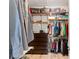 Organized walk-in closet with custom shelving and hanging racks for clothing and accessories at 2835 Hilliard Dr, Wesley Chapel, FL 33543