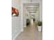 Light and bright hallway with tile flooring, leading to the living area and providing a welcoming entrance at 2835 Hilliard Dr, Wesley Chapel, FL 33543