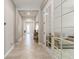 Inviting hallway featuring tile floors, neutral walls, and bright natural light at 2835 Hilliard Dr, Wesley Chapel, FL 33543