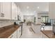 Bright kitchen with granite countertops, white cabinets, stainless appliances, and a dining area at 2835 Hilliard Dr, Wesley Chapel, FL 33543