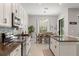Well-lit kitchen and dining area featuring a granite countertop, and stainless steel appliances at 2835 Hilliard Dr, Wesley Chapel, FL 33543
