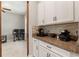 Kitchen area featuring a coffee bar with white cabinets, granite countertops, and stainless steel appliances at 2835 Hilliard Dr, Wesley Chapel, FL 33543
