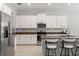 Modern kitchen featuring stainless steel appliances, granite countertops, and white cabinetry at 2835 Hilliard Dr, Wesley Chapel, FL 33543