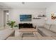Comfortable living room with neutral colors, tiled floor, and a large screen television at 2835 Hilliard Dr, Wesley Chapel, FL 33543