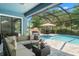 Inviting screened-in pool with seating area and luxurious lounge space in a backyard oasis at 2835 Hilliard Dr, Wesley Chapel, FL 33543