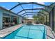 Stunning screened-in pool with plenty of seating and lounge space, perfect for entertaining at 2835 Hilliard Dr, Wesley Chapel, FL 33543