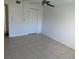 Clean, bright bedroom featuring neutral walls, tile flooring, ceiling fan and a closet at 2860 Somerset Park Dr # 202, Tampa, FL 33613