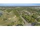 Aerial view of the property showcasing its proximity to the golf course, trees and surrounding area at 2969 Talon Dr, Clearwater, FL 33761