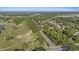 Aerial view of the property showcasing its proximity to the golf course, trees and surrounding area at 2969 Talon Dr, Clearwater, FL 33761