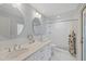 Bathroom features double vanity, tiled shower, and decorative floor tiles at 2969 Talon Dr, Clearwater, FL 33761