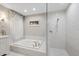 Bright bathroom with soaking tub and glass enclosed tiled shower; features recessed ceiling lighting at 2969 Talon Dr, Clearwater, FL 33761