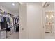 Walk-in closet featuring ample shelving and storage, with a view to bathroom at 2969 Talon Dr, Clearwater, FL 33761