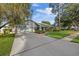 Home with a large driveway, lush landscaping, and well-maintained lawn at 2969 Talon Dr, Clearwater, FL 33761