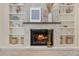 Close up of fireplace with decorative stone surround, built-in shelving, and decorative items at 2969 Talon Dr, Clearwater, FL 33761