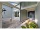 Inviting front entrance with double doors, unique architectural features, and lush tropical landscaping at 2969 Talon Dr, Clearwater, FL 33761