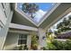 View of front porch with inviting architectural details and well-manicured landscaping at 2969 Talon Dr, Clearwater, FL 33761