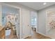 Hallway view revealing neutral walls and wood flooring, and leading to a giraffe-themed bedroom and a full bathroom at 2969 Talon Dr, Clearwater, FL 33761