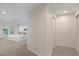 Hallway view leading into a bright bedroom featuring French doors and neutral decor at 2969 Talon Dr, Clearwater, FL 33761