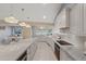 Open concept kitchen with stainless steel appliances, marble countertops, and pendant lighting at 2969 Talon Dr, Clearwater, FL 33761