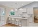 Bright kitchen features white cabinetry, a large island, and stainless steel appliances at 2969 Talon Dr, Clearwater, FL 33761