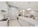 Bright kitchen with white cabinetry, marble countertops, and stainless steel appliances at 2969 Talon Dr, Clearwater, FL 33761