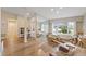 Bright living room featuring wood floors, large windows, and a pilates machine at 2969 Talon Dr, Clearwater, FL 33761